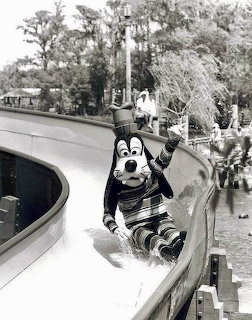 Goofy character on curved water slide in black and white vintage photo