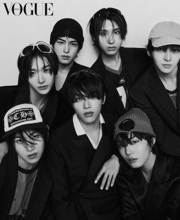 Black-and-white studio portrait of six young men posing closely together