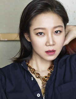 Portrait of Gong Hyo Jin with dark hair, gold chain necklace, and dark blue shirt