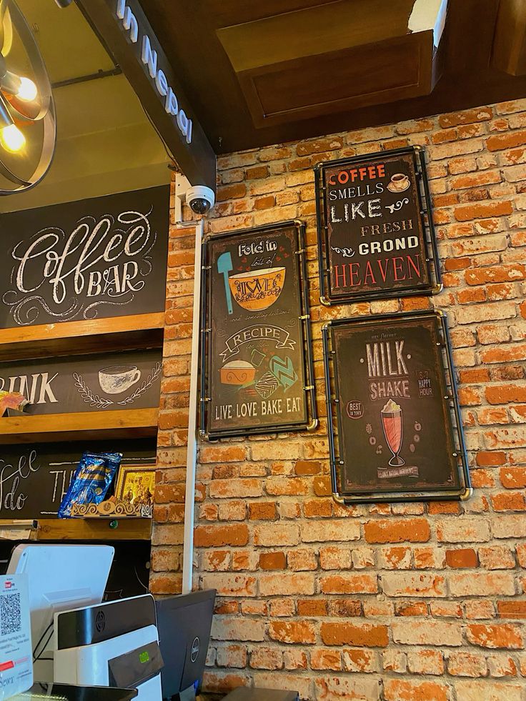 Brick wall with vintage coffee and baking signs in a coffee bar interior
