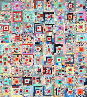 Colorful patchwork quilt with geometric log cabin blocks in bright fabrics