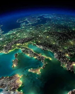 Satellite image of Italy and surrounding Europe at night with city lights visible from space