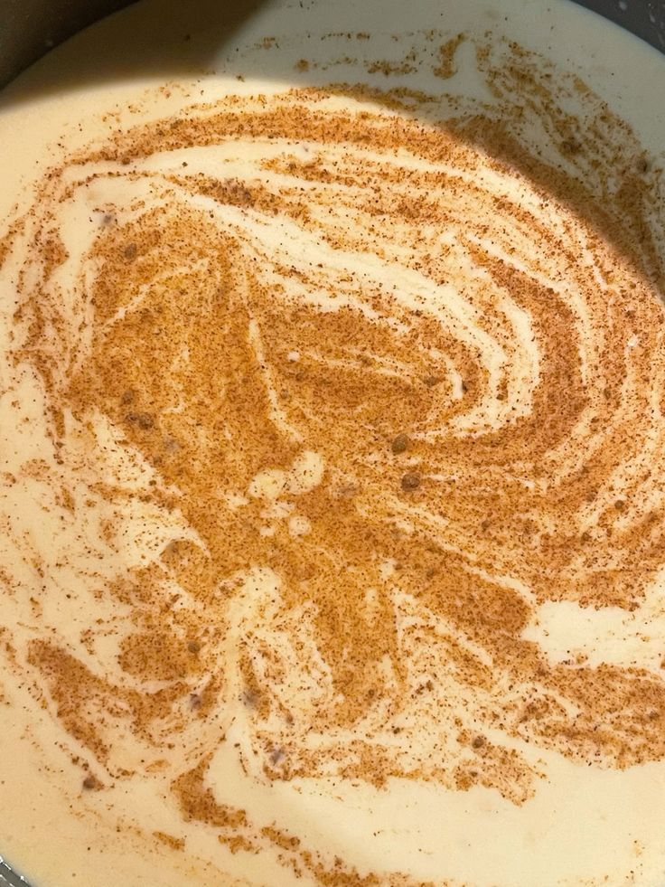 Coffee with cinnamon swirl design in milk foam