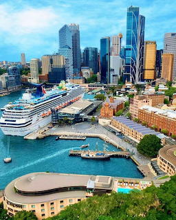 Aerial view of cruise ship docked at Sydney Circular Quay with city skyscrapers in background