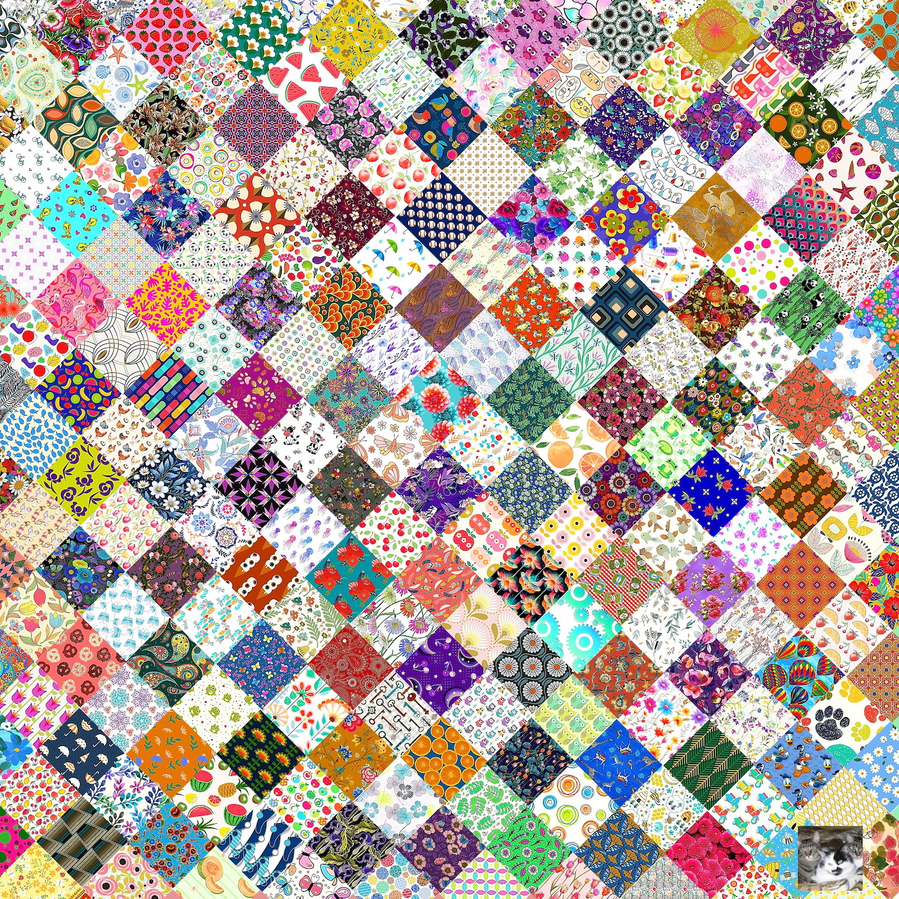 Colorful patchwork quilt with hundreds of small printed fabric squares in diamond pattern arrangement