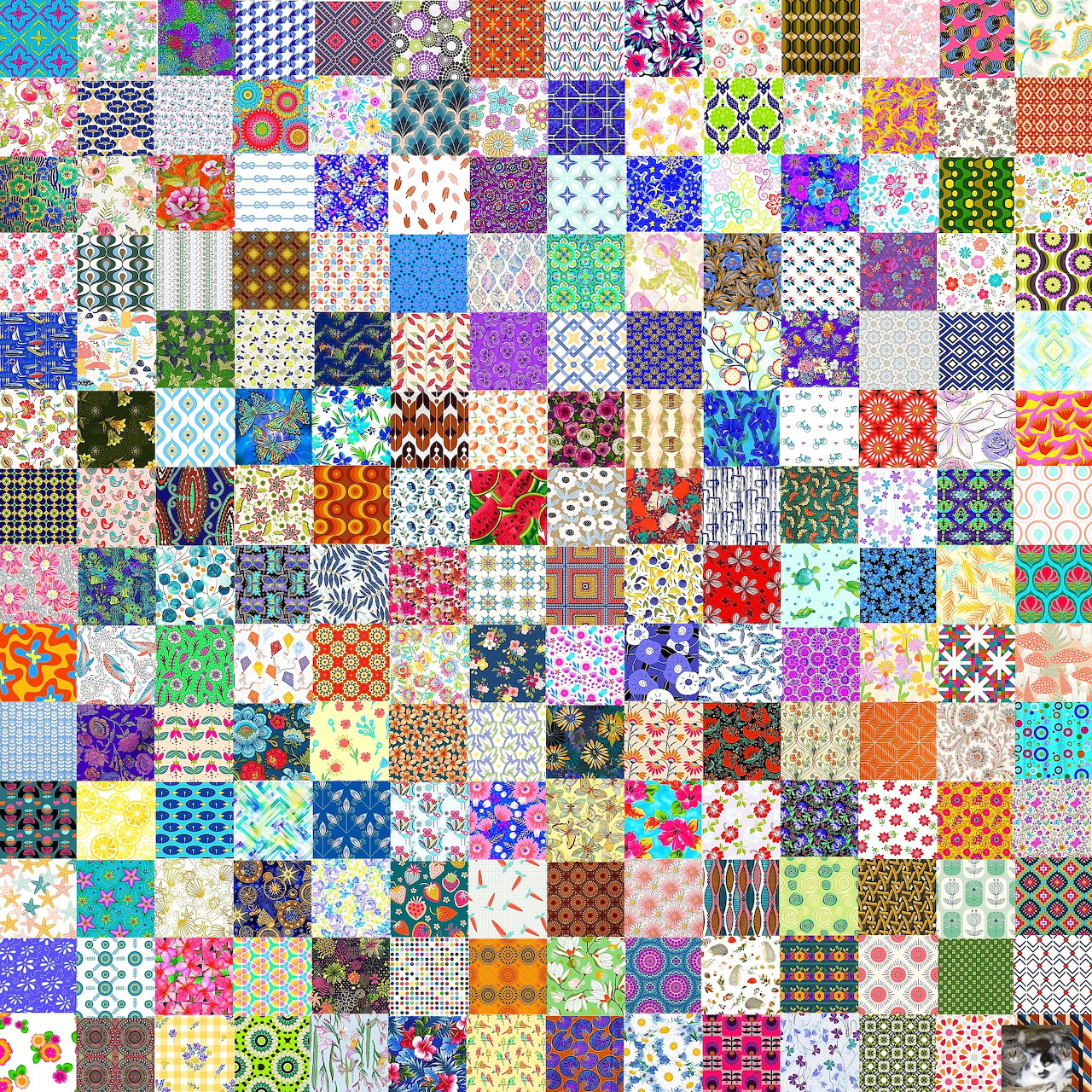 Colorful patchwork quilt with hundreds of small patterned fabric squares in a grid arrangement