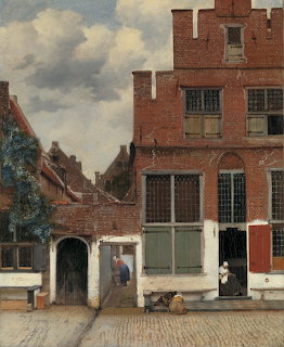 Painting of old brick houses on a cobblestone street in Delft with a few small figures