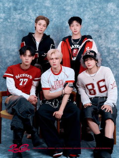Five young men in red and white streetwear posing together in a studio group photo
