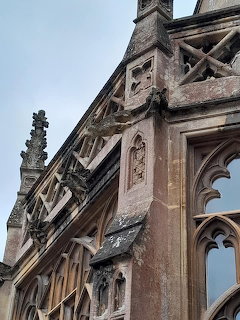 Gothic Revival stone gargoyles and ornate architectural details on the upper facade of Tyntesfield House