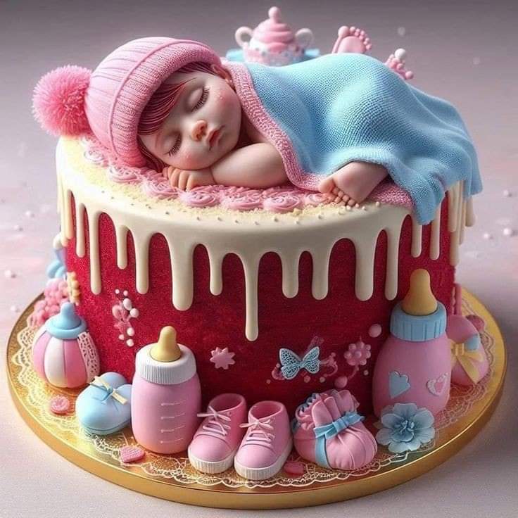 Sleeping baby on a pink drip cake with baby bottles, booties, and pastel decorations