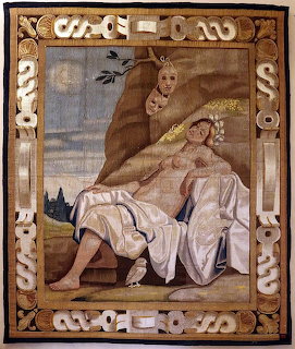 Renaissance tapestry showing reclining woman with cherubs, night sky motifs, ornate border with decorative elements