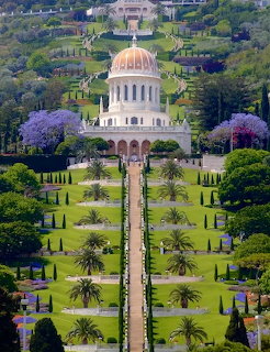 Bahai Temple with golden dome surrounded by terraced gardens and green lawns in Haifa, Israel