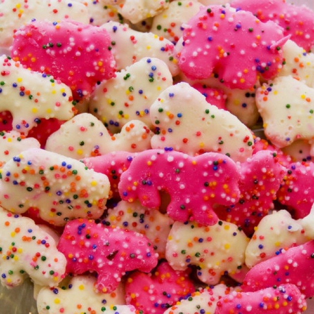 Close-up of pink and white animal crackers with colorful sprinkles