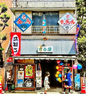 Colorful vintage Japanese shop with signs, balloons, and traditional storefront architecture