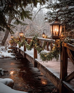 Wooden bridge with lit lanterns and evergreen decorations over a stream in snowy winter forest