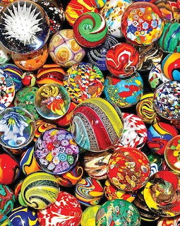 Collection of colorful hand-painted ceramic bowls with intricate patterns viewed from above