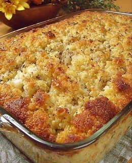 Glass baking dish of golden brown cornbread dressing with a crisp crumbly top