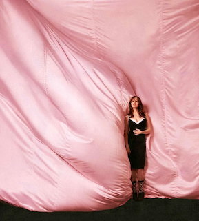 Woman by Pink Drapes
