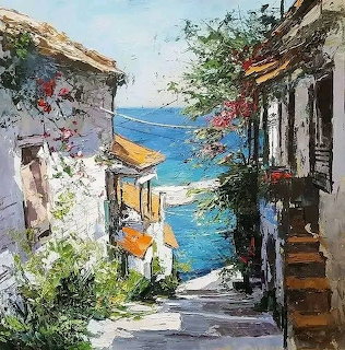 Painted alley between white buildings with flowers and ocean view