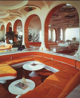Retro 1970s futuristic interior with orange curved sofas, white tables, and organic arched architecture