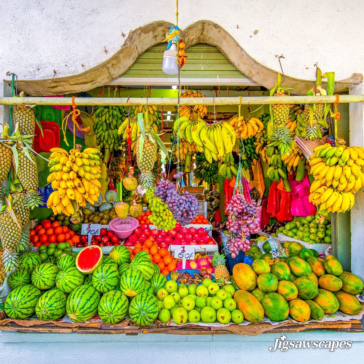 Colorful tropical fruit market stand with bananas, watermelons, pineapples, and assorted fresh produce