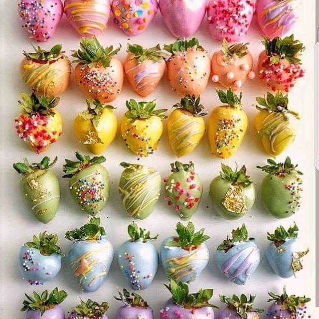 Colorful chocolate-covered strawberries with sprinkles arranged in rows