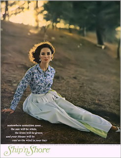 Vintage-style portrait of a woman sitting on a grassy hillside in a floral blouse and white pants
