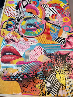 Colorful pop art portrait of woman's face made from geometric patterns, dots, and bold graphic shapes