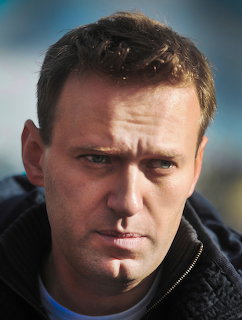 Close-up portrait of Alexey Navalny in a dark jacket outdoors