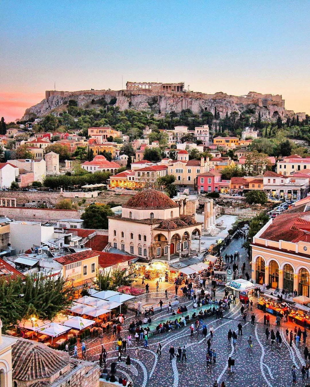 Aerial view of Athens with the Acropolis on a hill at sunset and Monastiraki Square below