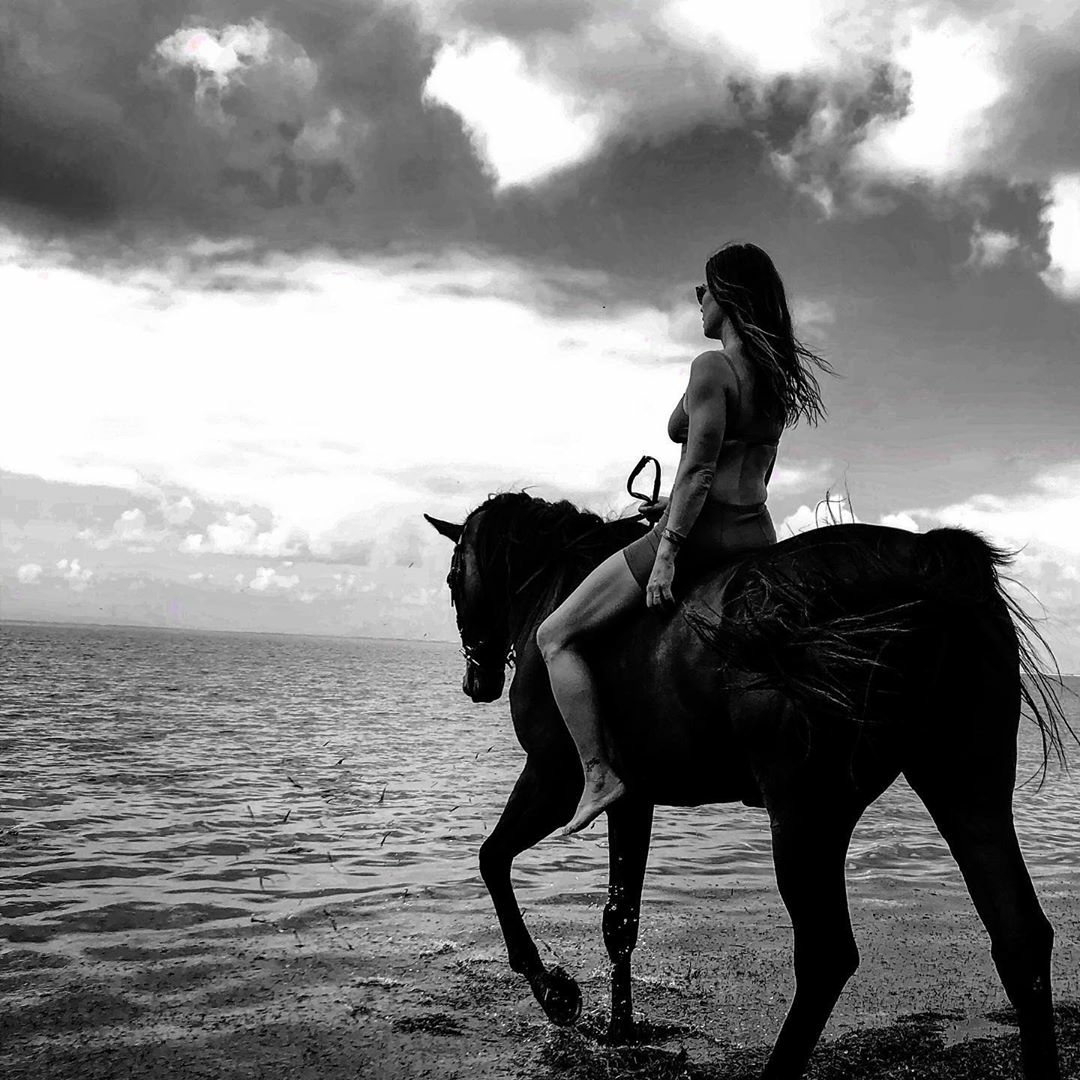 Woman Riding Horse by Ocean