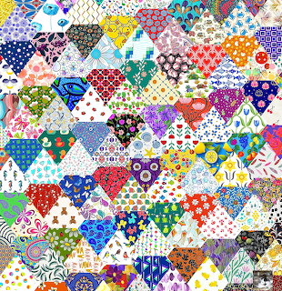Dense colorful patchwork quilt made of small triangular fabric pieces with various patterns including polka dots and florals