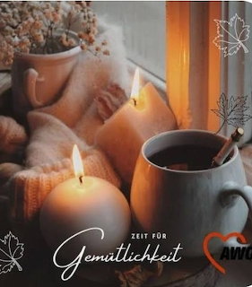Cozy autumn still life with candles, coffee mug, and knit blanket by a decorated window