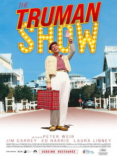 The Truman Show movie poster featuring Jim Carrey in white suit with red suitcase on suburban street
