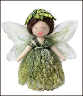 Needle-felted fairy doll in green wool dress with white wings and leaf headpiece