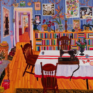 Colorful painted interior of artist studio with striped furniture, blue walls full of framed art, and dining table