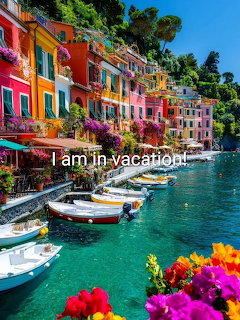 Colorful houses along Italian coastal village waterfront with boats and flowers in foreground