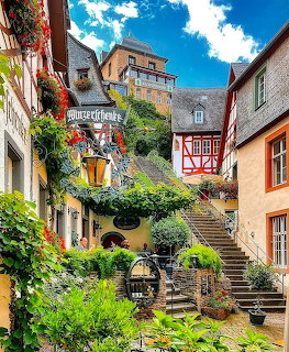 Picturesque street in Beilstein Germany with half-timbered houses, green vines, and stone stairs