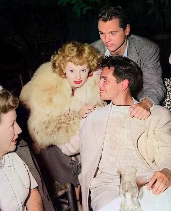Colorized vintage photo of Lucille Ball in fur stole with Desi Arnaz and others at an outdoor gathering