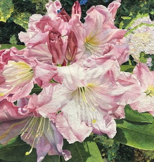 Art quilt showing large pink flowers with white centers and green leaves made from fabric pieces