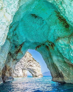 Turquoise sea cave with natural stone arch opening to blue Mediterranean waters