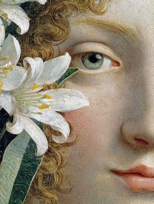 Close-up of a Renaissance painting showing a woman's face with golden curls and white lilies