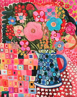 Colorful folk art painting of flowers in blue pitcher with patchwork geometric background