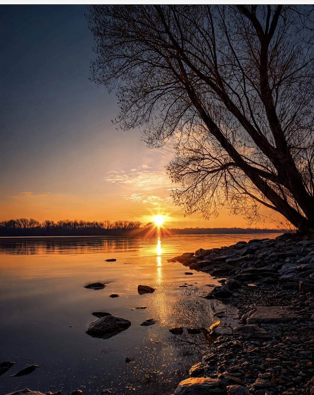 Sunrise with warm glowing sky over a calm horizon