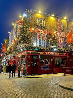 Temple Bar pub in Dublin at night with Christmas lights on red brick building