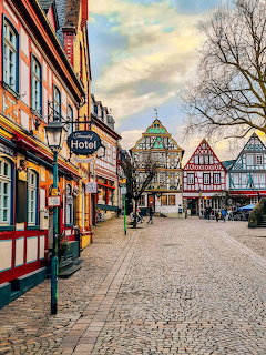 Colorful half-timbered buildings along a cobblestone street in a German town