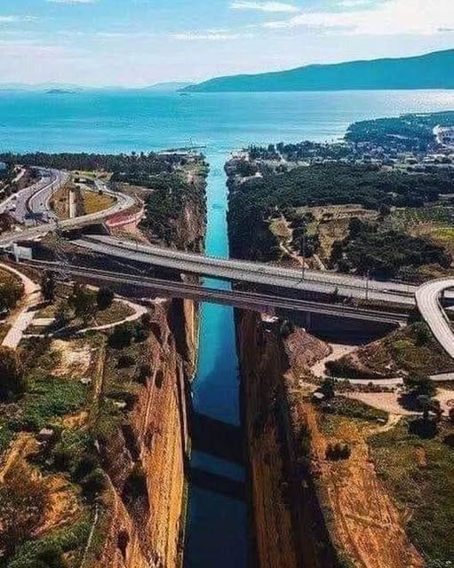 Aerial view of Corinth Canal with bridges crossing narrow waterway between cliffs