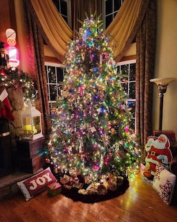 Decorated Christmas tree with colorful lights in a cozy living room