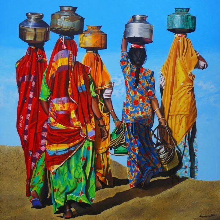 Five women in vibrant sarees carrying water pots on their heads walking in desert landscape