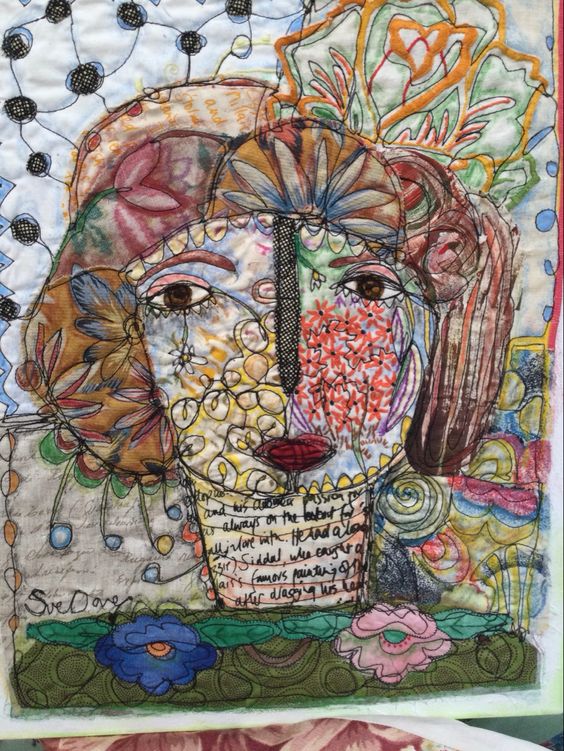 Colorful mixed media textile art of a woman's face with embroidery, fabric patches, and floral motifs